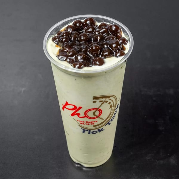A Pho Tick Tock Vietnamese avocado smoothie with boba pearls on a dark surface.
