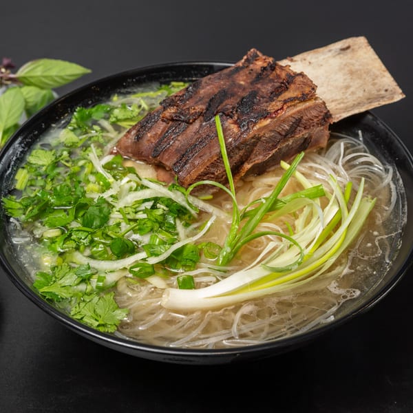 Pho Tick Tock's pho with a large grilled short rib, noodles, cilantro, and green onions.